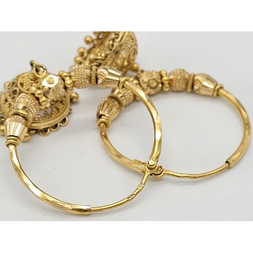 749 - Withdrawn
Two 22 K yellow gold bangles and a pair of earrings, Total weight: 53 g. REF: 01012344