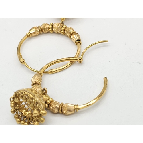 749 - Withdrawn
Two 22 K yellow gold bangles and a pair of earrings, Total weight: 53 g. REF: 01012344