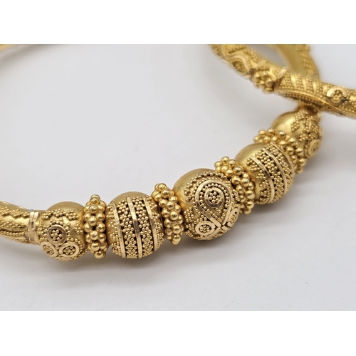 749 - Withdrawn
Two 22 K yellow gold bangles and a pair of earrings, Total weight: 53 g. REF: 01012344