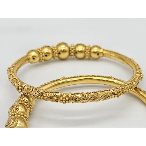 749 - Withdrawn
Two 22 K yellow gold bangles and a pair of earrings, Total weight: 53 g. REF: 01012344