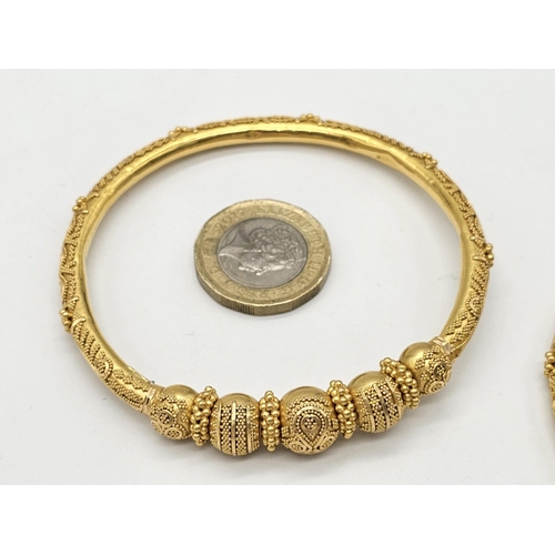 749 - Withdrawn
Two 22 K yellow gold bangles and a pair of earrings, Total weight: 53 g. REF: 01012344