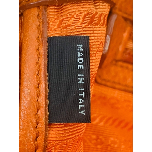 1456 - A Prada Burnt Orange Tote Bag. Soft leather with gilded hardware. Inner zipped and flap compartments... 