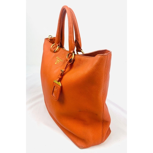 1456 - A Prada Burnt Orange Tote Bag. Soft leather with gilded hardware. Inner zipped and flap compartments... 