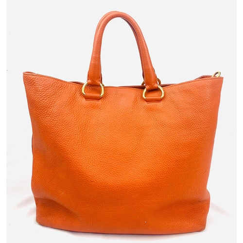 1456 - A Prada Burnt Orange Tote Bag. Soft leather with gilded hardware. Inner zipped and flap compartments... 