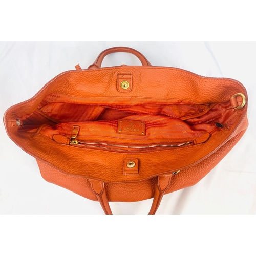 1456 - A Prada Burnt Orange Tote Bag. Soft leather with gilded hardware. Inner zipped and flap compartments... 