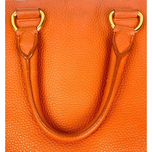 1456 - A Prada Burnt Orange Tote Bag. Soft leather with gilded hardware. Inner zipped and flap compartments... 