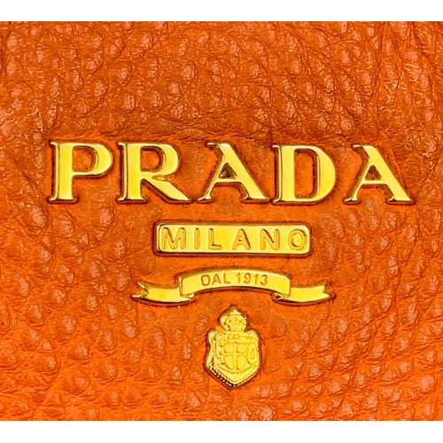 1456 - A Prada Burnt Orange Tote Bag. Soft leather with gilded hardware. Inner zipped and flap compartments... 