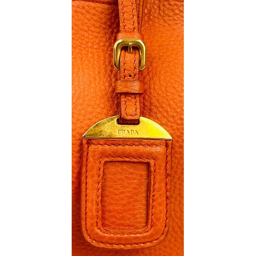 1456 - A Prada Burnt Orange Tote Bag. Soft leather with gilded hardware. Inner zipped and flap compartments... 