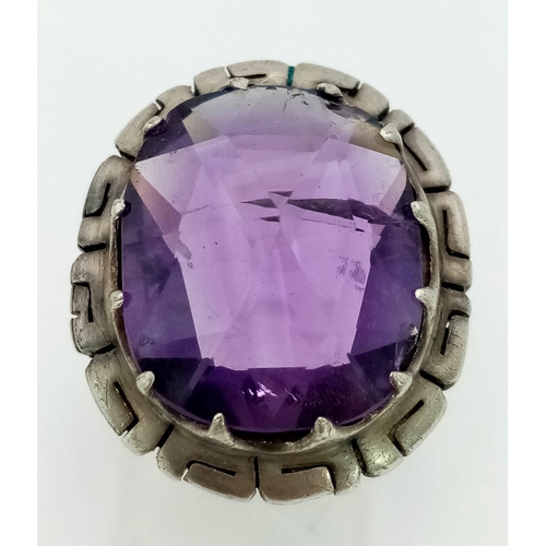 1092 - A 925 Silver and Amethyst Ring. Large faceted stone. Size N