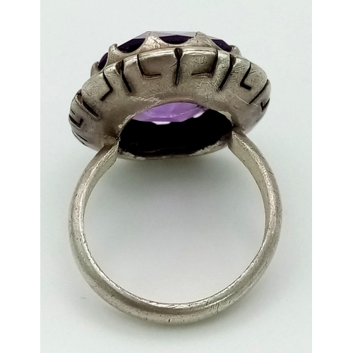 1092 - A 925 Silver and Amethyst Ring. Large faceted stone. Size N