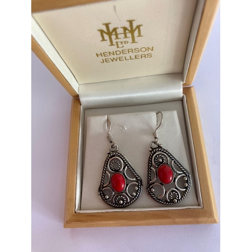 377 - Pair of SILVER EARRINGS set with CORAL CABOCHON to centre. Drop style earrings with ornate silver op... 