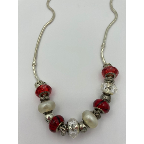 412 - SILVER NECKLACE mounted with SILVER and SILVER GLASS CHARMS  in shades of burgundy and red. 50 cm ap... 