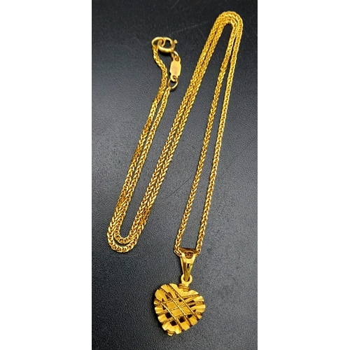 511 - A mixed lot of 21 K yellow gold pair of earrings and a chain with a heart shaped pendant (total weig... 