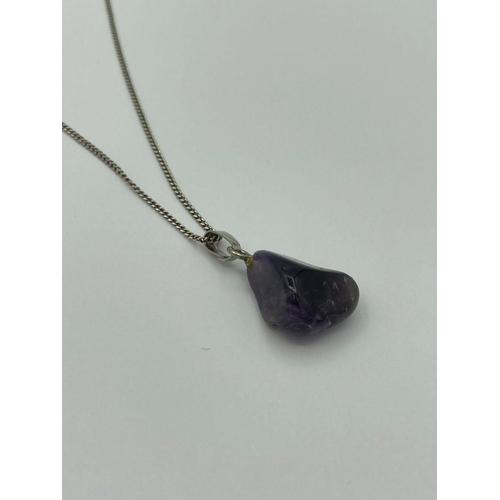 643 - Rough AMETHYST GEMSTONE PENDANT smooth polished and mounted on a SILVER chain.