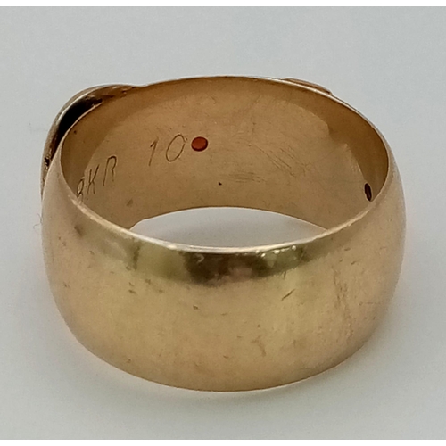 750 - A Vintage 9K Yellow Gold Buckle Ring with Red Stone Decoration. Size P 1/2. 7.73g total weight.