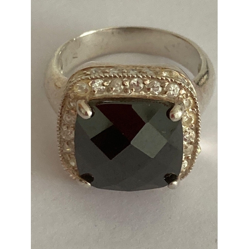 834 - SILVER RING Having large square faceted black gemstone mounted to top with clear white stone surroun... 