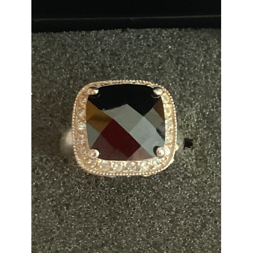 834 - SILVER RING Having large square faceted black gemstone mounted to top with clear white stone surroun... 