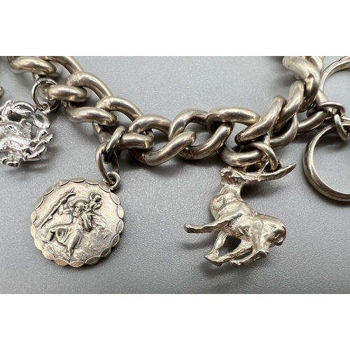 1255 - A Vintage 925 Silver Charm Bracelet with a Heart Clasp. 18cm. Total weight - 60g