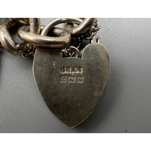 1255 - A Vintage 925 Silver Charm Bracelet with a Heart Clasp. 18cm. Total weight - 60g