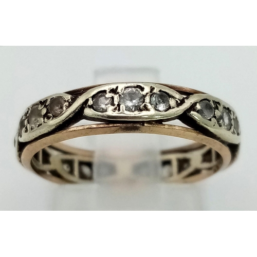 1209 - A 9K White and Yellow Gold White Stone Eternity Ring. Size M. 2.65g total weight.