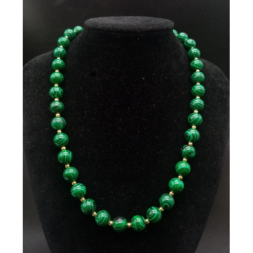 1507 - A Malachite Beaded Necklace with Gilded Spacers. 44cm