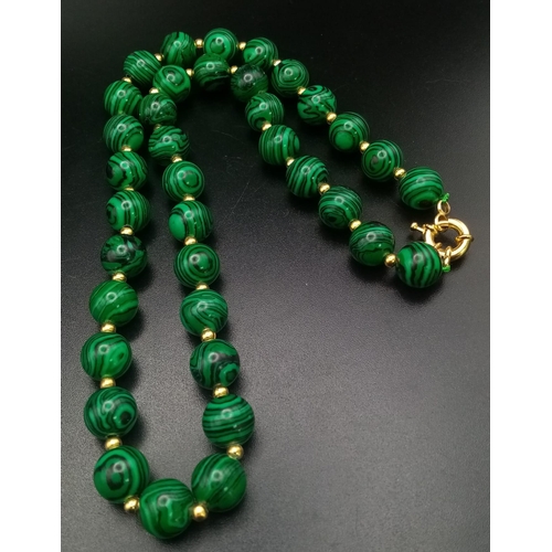 1507 - A Malachite Beaded Necklace with Gilded Spacers. 44cm