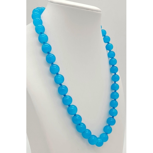 1030 - A Bright Blue Topaz Beaded Necklace. 10mm beads. 44cm necklace length.