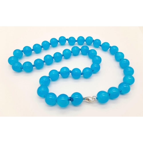 1030 - A Bright Blue Topaz Beaded Necklace. 10mm beads. 44cm necklace length.