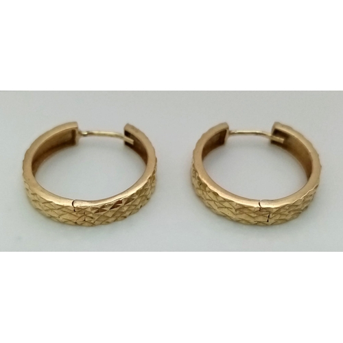 1223 - A Pair of 9K Yellow Gold Hoop Earrings. Geometric decoration. 2.25g total weight.