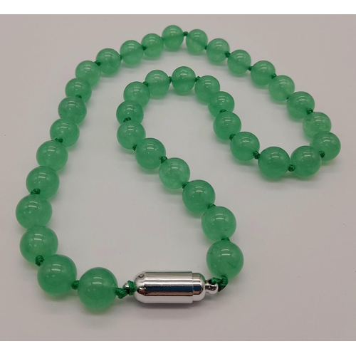 779 - A Pale Green Jade Bead Necklace with Magnetic Clasp. 10mm beads. 44cm necklace length.