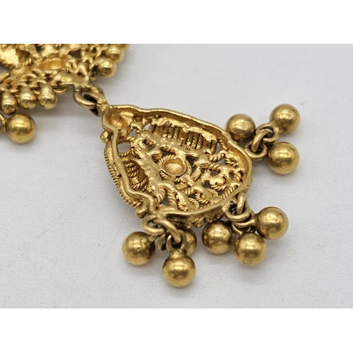 712 - Withdrawn
A yellow gold mixed lot consisting of: 
22 K Necklace and pair of earrings (butterfly miss... 