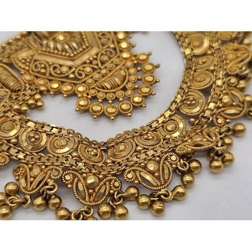 712 - Withdrawn
A yellow gold mixed lot consisting of: 
22 K Necklace and pair of earrings (butterfly miss... 