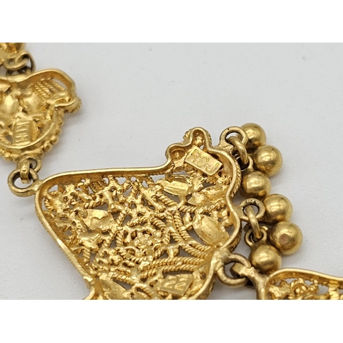 712 - Withdrawn
A yellow gold mixed lot consisting of: 
22 K Necklace and pair of earrings (butterfly miss... 