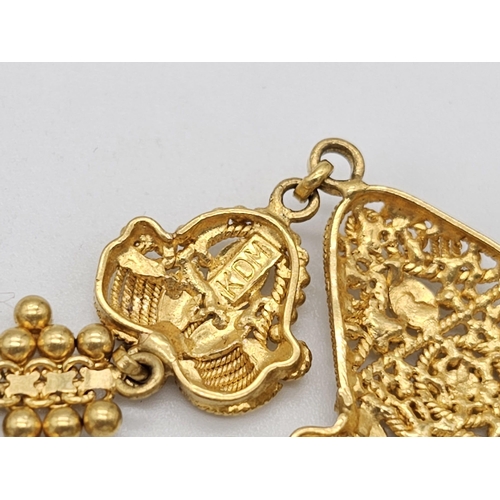 712 - Withdrawn
A yellow gold mixed lot consisting of: 
22 K Necklace and pair of earrings (butterfly miss... 