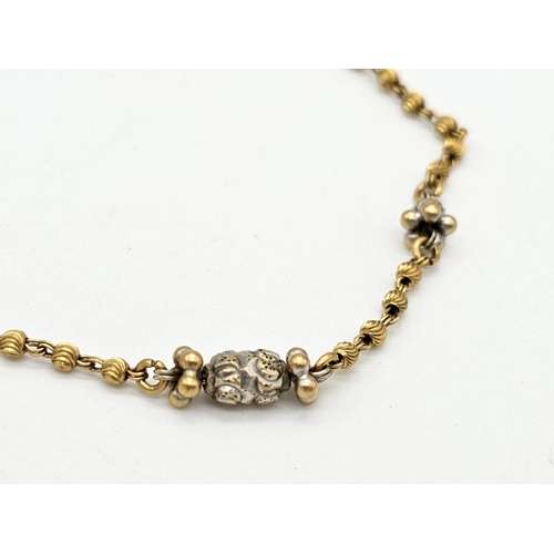 712 - Withdrawn
A yellow gold mixed lot consisting of: 
22 K Necklace and pair of earrings (butterfly miss... 