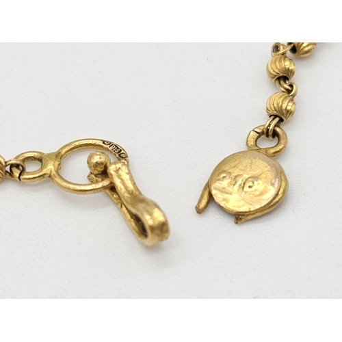 712 - Withdrawn
A yellow gold mixed lot consisting of: 
22 K Necklace and pair of earrings (butterfly miss... 