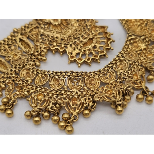 712 - Withdrawn
A yellow gold mixed lot consisting of: 
22 K Necklace and pair of earrings (butterfly miss... 