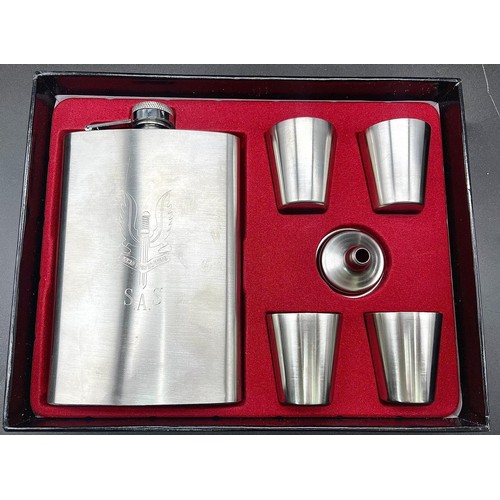 238 - An SAS engraved (WHO DARES WINS) white metal hip flask with four cups and filling funnel in original... 