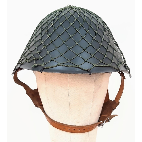 1364 - DDR M1956 steel helmet with cam net. As worn by East German border guards during the Cold War. A pie... 