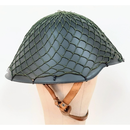 1364 - DDR M1956 steel helmet with cam net. As worn by East German border guards during the Cold War. A pie... 