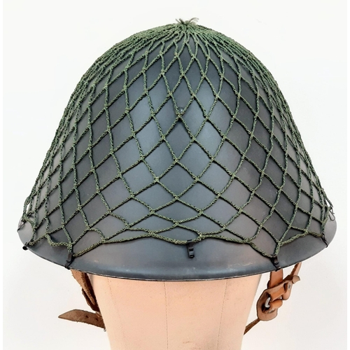 1364 - DDR M1956 steel helmet with cam net. As worn by East German border guards during the Cold War. A pie... 