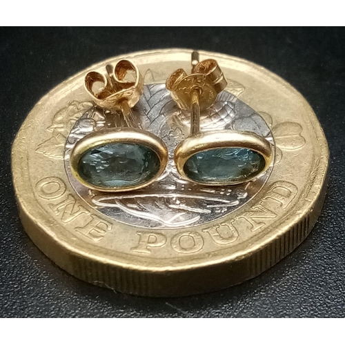 1415 - A Pair of 9K Gold Blue Stone Earrings. 0.5g total weight.