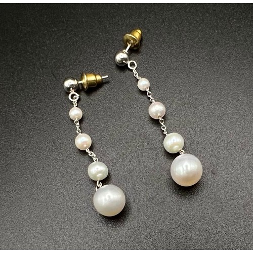 1148 - A Pair of 14K White Gold and Graduated Pearl Drop Earrings. 
4cm drop. 2.4g total weight.