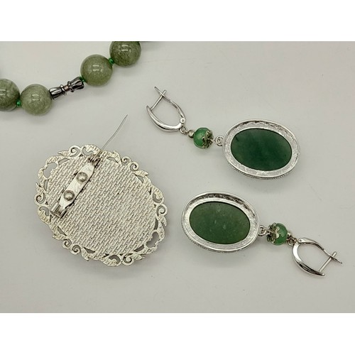 1037 - A Jade Jewellery Set. Comprising of an Opera Length Bead Necklace, a brooch - 5cm and a pair of drop... 