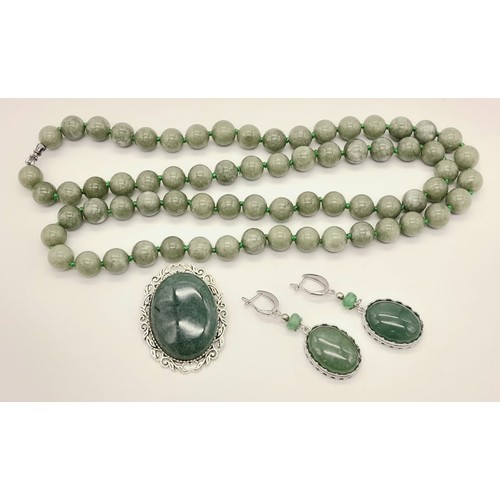 1037 - A Jade Jewellery Set. Comprising of an Opera Length Bead Necklace, a brooch - 5cm and a pair of drop... 