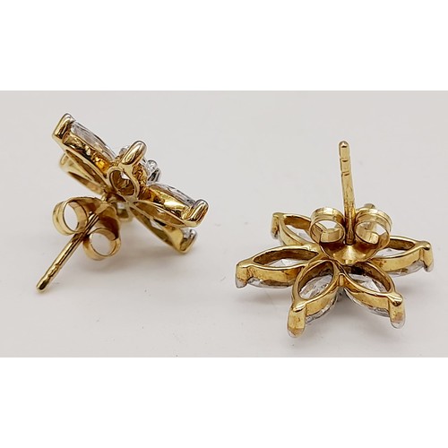 1279 - A Pair of Stunning 9K Gold Star Burst CZ Earrings. 2.6g total weight.