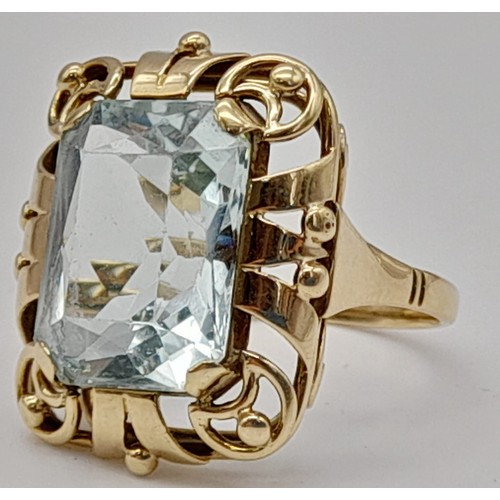 737 - Single stone aquamarine Ring. 11cts approx. Fancy ‘40’s decorated frame setting. Set in high karat g... 