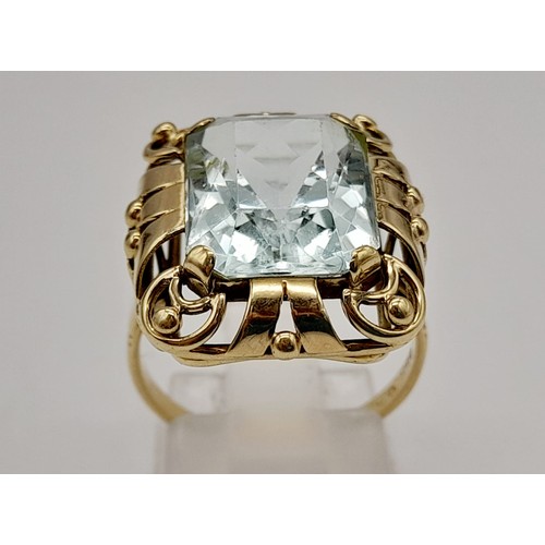 737 - Single stone aquamarine Ring. 11cts approx. Fancy ‘40’s decorated frame setting. Set in high karat g... 