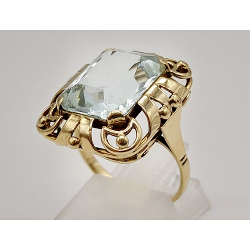 737 - Single stone aquamarine Ring. 11cts approx. Fancy ‘40’s decorated frame setting. Set in high karat g... 