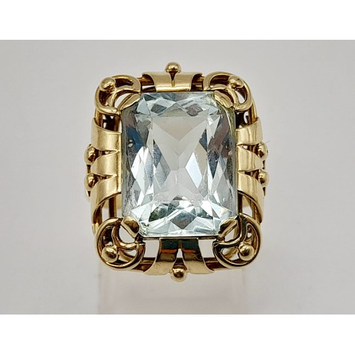 737 - Single stone aquamarine Ring. 11cts approx. Fancy ‘40’s decorated frame setting. Set in high karat g... 